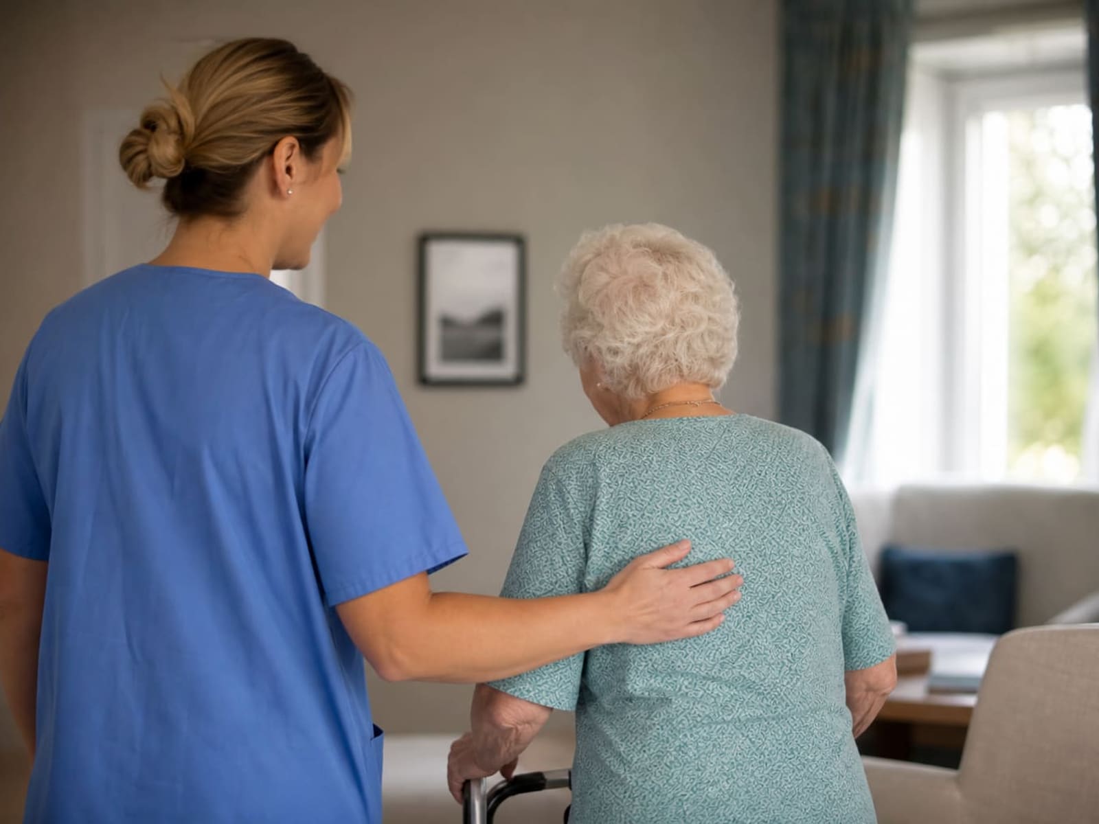Care staff walking a bright hospital corridor.