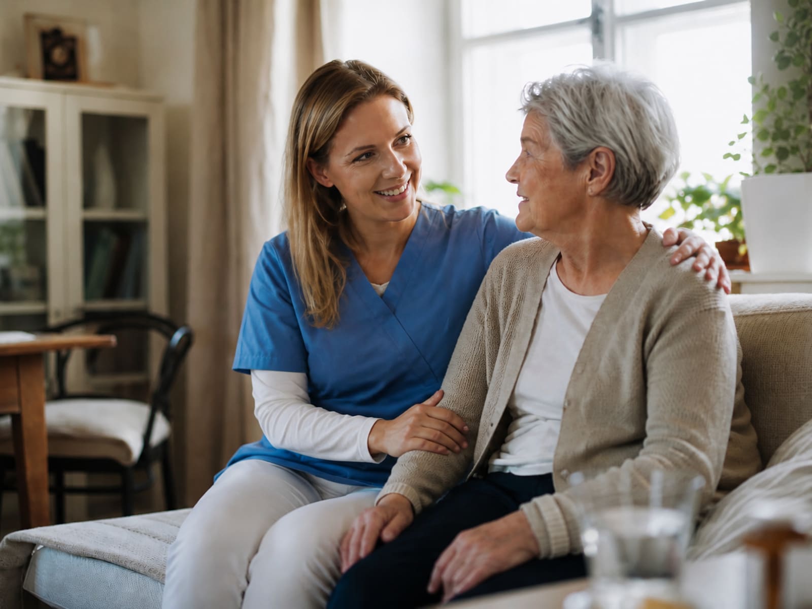 A care worker supporting an older adult at home.